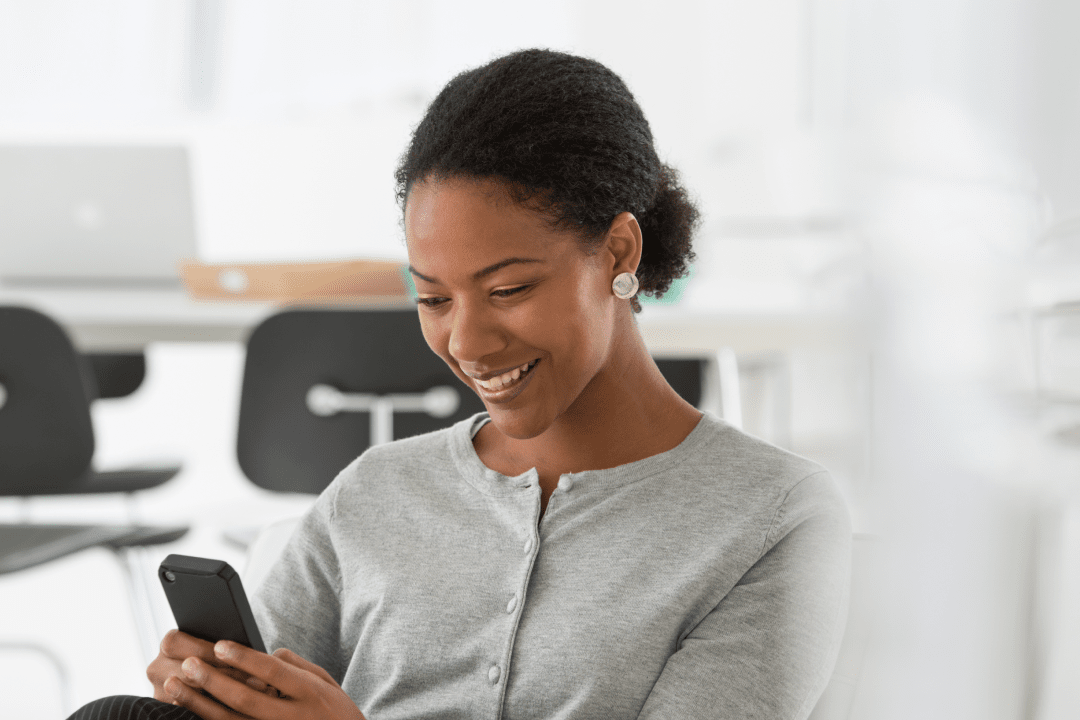 Happy woman using her phone